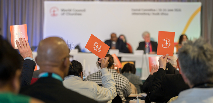 24 June 2025, Johannesburg, South Africa: Orange consensus cards are raised in affirmation of what has been proposed at the 2025 Central Committee meeting of the World Council of Churches taking place in Johannesburg (South Africa) from 18 to 24 June