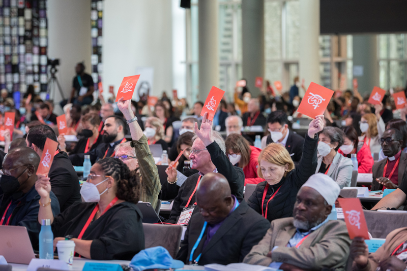 8 September 2022, Karlsruhe, Germany: Assembly participants raise orange consensus cards in affirmation of what is said during a closing business plenary at the 11th Assembly of the World Council of Churches, held in Karlsruhe, Germany from 31 August